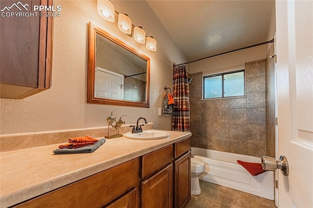 full bathroom featuring a textured ceiling, toilet, tile patterned floors, shower / bath combo with shower curtain, and vanity