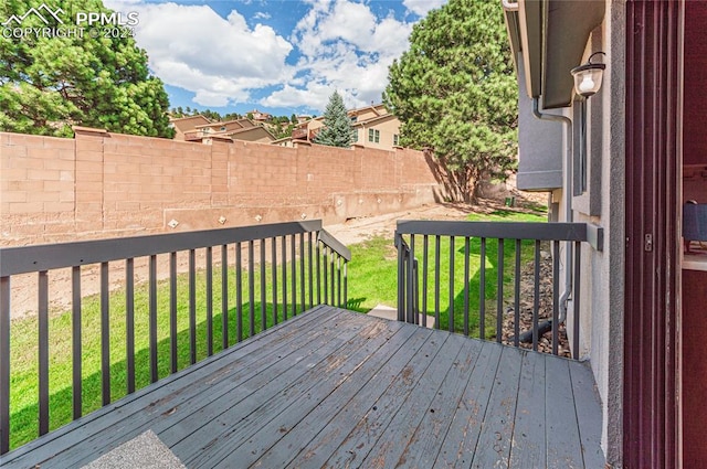 wooden terrace with a yard