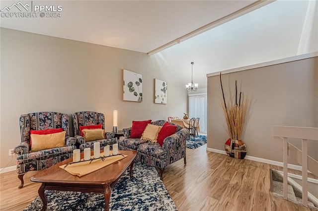 living room with a chandelier, vaulted ceiling, and hardwood / wood-style flooring