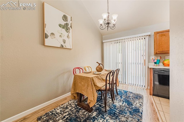 dining space with light hardwood / wood-style floors, vaulted ceiling, and an inviting chandelier