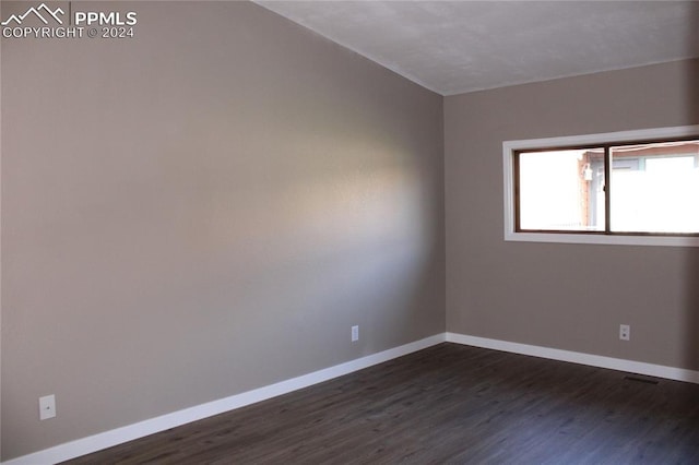 empty room featuring dark hardwood / wood-style flooring