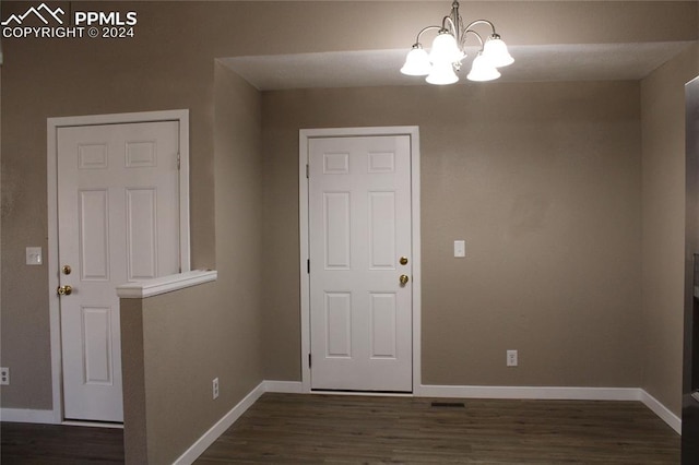 foyer featuring a chandelier and dark hardwood / wood-style flooring