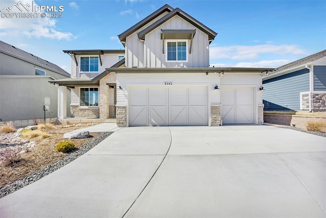 8542 Noreen Falls Dr, Colorado Springs, CO 80924 - view of front of property with board and batten siding, concrete driveway, stone siding, and an attached garage