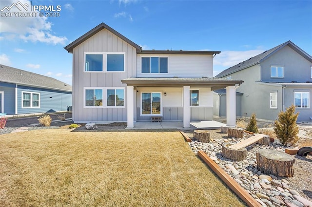 8542 Noreen Falls Dr, Colorado Springs, CO 80924 - rear view of house with board and batten siding, a patio, and a lawn