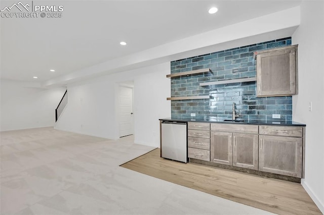8542 Noreen Falls Dr, Colorado Springs, CO 80924 - indoor wet bar with recessed lighting, stainless steel dishwasher, tasteful backsplash, light wood-type flooring, and baseboards