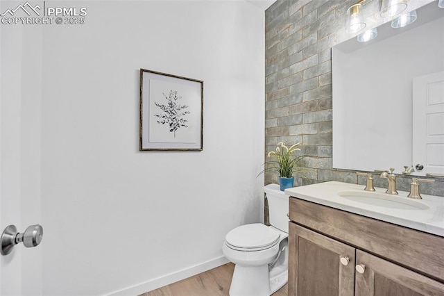8542 Noreen Falls Dr, Colorado Springs, CO 80924 - bathroom featuring wood finished floors, baseboards, toilet, and vanity