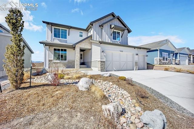 8542 Noreen Falls Dr, Colorado Springs, CO 80924 - view of front of property featuring board and batten siding, stone siding, driveway, and an attached garage
