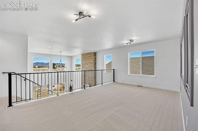 8542 Noreen Falls Dr, Colorado Springs, CO 80924 - empty room featuring light colored carpet, a chandelier, and baseboards
