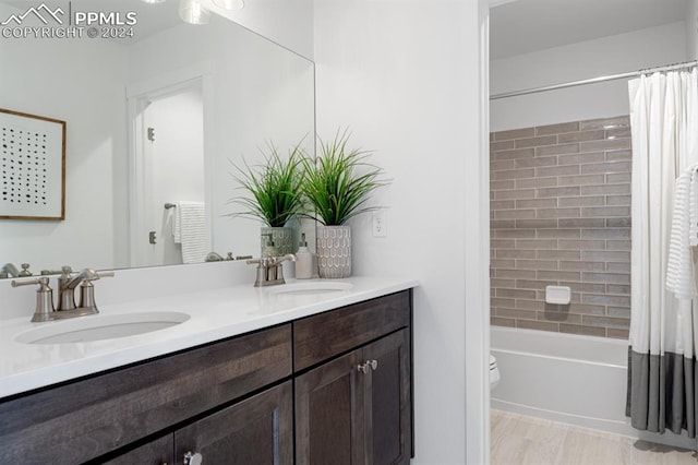 full bathroom with vanity, toilet, and shower / tub combo