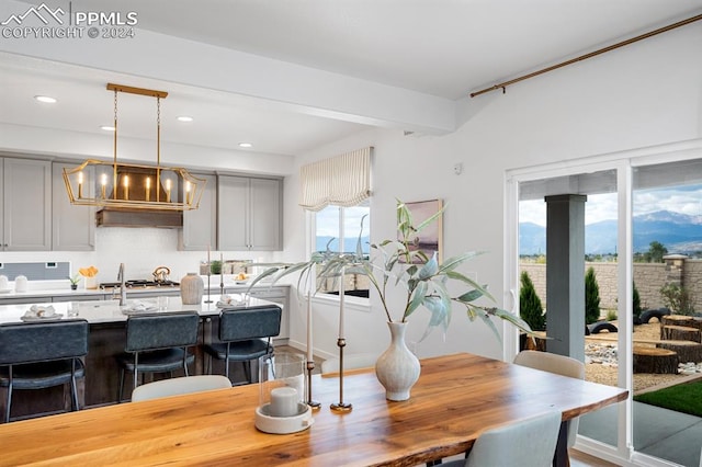 dining room with beamed ceiling and hardwood / wood-style floors