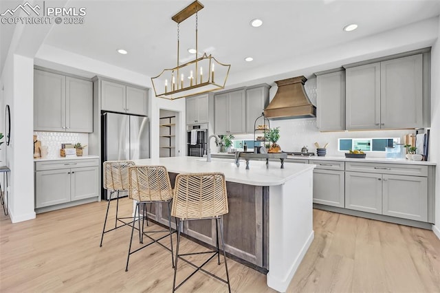 8542 Noreen Falls Dr, Colorado Springs, CO 80924 - kitchen featuring stainless steel appliances, gray cabinets, custom range hood, recessed lighting, and tasteful backsplash