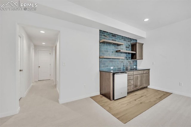 8542 Noreen Falls Dr, Colorado Springs, CO 80924 - indoor wet bar with backsplash, recessed lighting, dishwashing machine, baseboards, and light wood finished floors