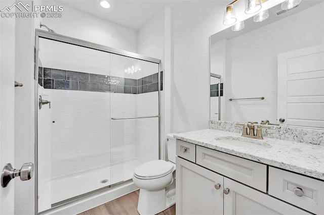 8542 Noreen Falls Dr, Colorado Springs, CO 80924 - full bathroom with wood finished floors, a shower stall, toilet, vanity, and recessed lighting