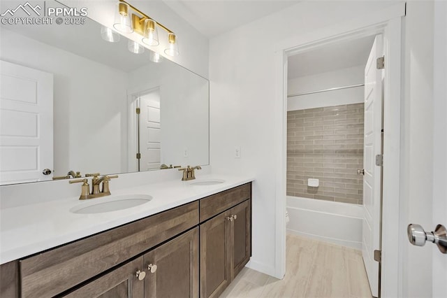 8542 Noreen Falls Dr, Colorado Springs, CO 80924 - full bathroom with double vanity, shower / bathtub combination, wood finished floors, and toilet