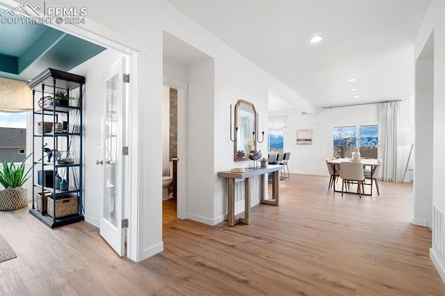 hallway with light hardwood / wood-style floors