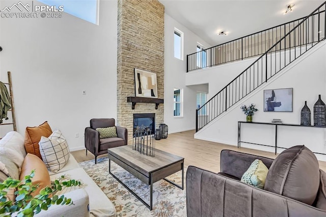 8542 Noreen Falls Dr, Colorado Springs, CO 80924 - living room featuring a high ceiling, plenty of natural light, stairs, and wood finished floors