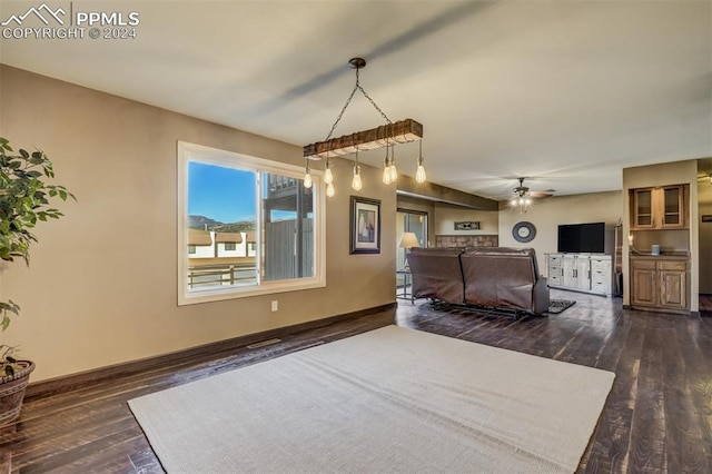 interior space with dark wood-type flooring and ceiling fan