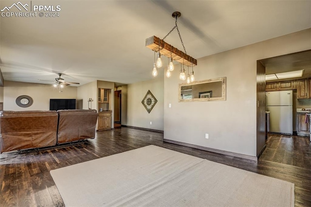 living room featuring dark wood-type flooring and ceiling fan