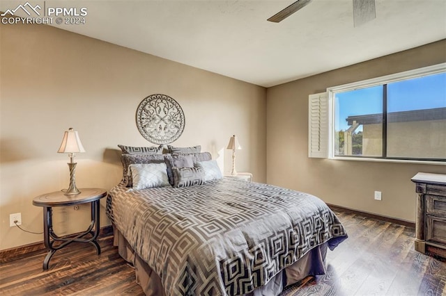 bedroom with ceiling fan and dark hardwood / wood-style floors