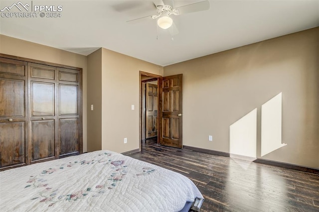 bedroom with dark hardwood / wood-style flooring, a closet, and ceiling fan