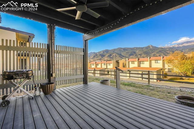 wooden deck with a mountain view and ceiling fan