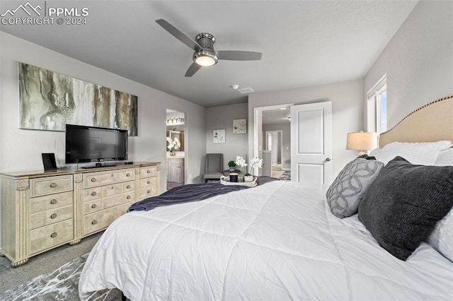 bedroom with ensuite bath, carpet, and ceiling fan