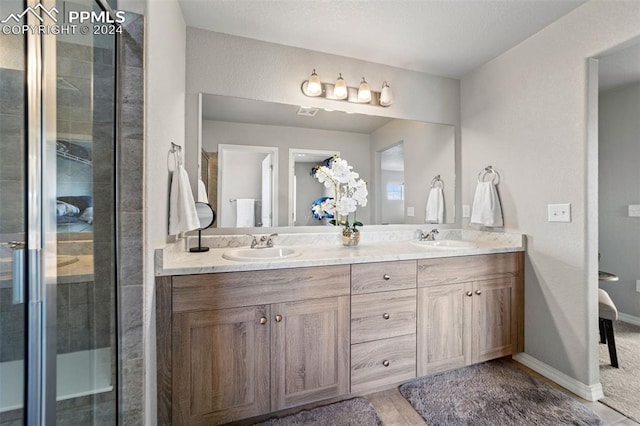 bathroom featuring vanity and an enclosed shower