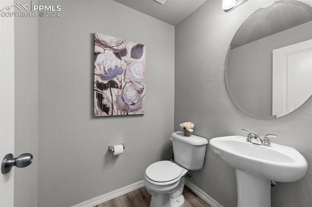 bathroom featuring toilet and hardwood / wood-style flooring