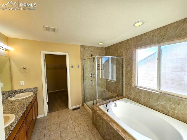 bathroom featuring vanity, tile patterned floors, and separate shower and tub