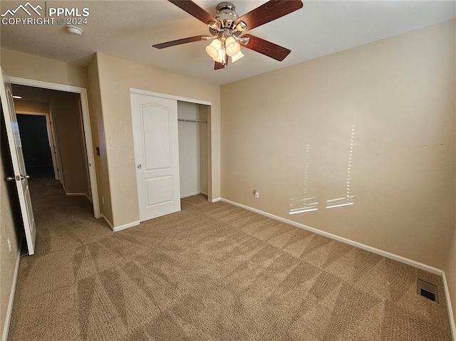 unfurnished bedroom featuring a closet, ceiling fan, and carpet