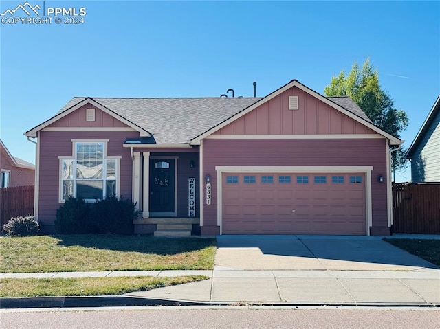 view of front facade featuring a front yard and a garage