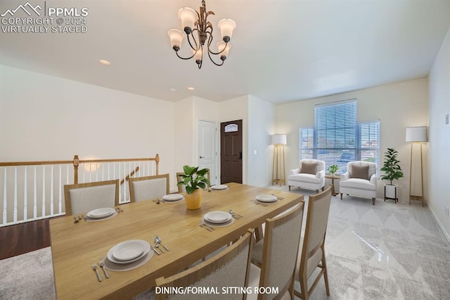 carpeted dining area with a chandelier