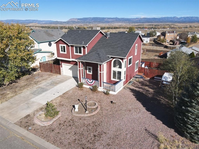 view of front facade featuring a mountain view and a garage