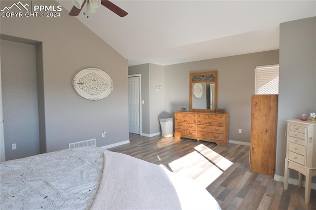 bedroom with dark hardwood / wood-style flooring, lofted ceiling, a closet, and ceiling fan