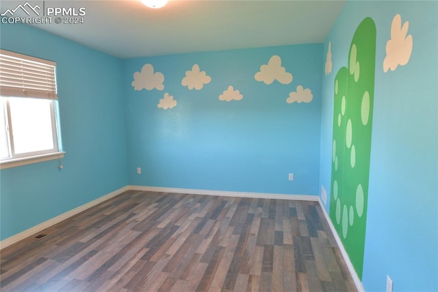 empty room featuring dark hardwood / wood-style flooring