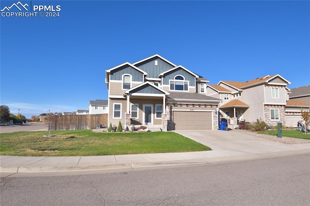 craftsman inspired home featuring a front lawn and a garage