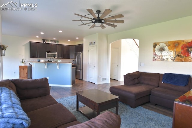 living room featuring ceiling fan and hardwood / wood-style floors