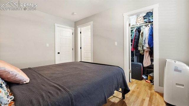 bedroom featuring a closet and light hardwood / wood-style flooring