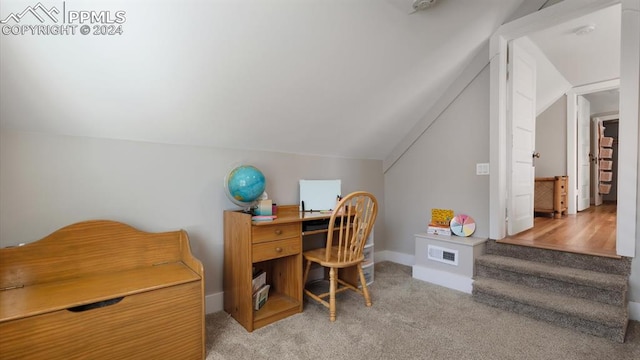 home office with light carpet and lofted ceiling