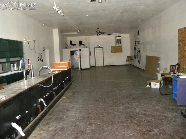 garage with ceiling fan and white fridge