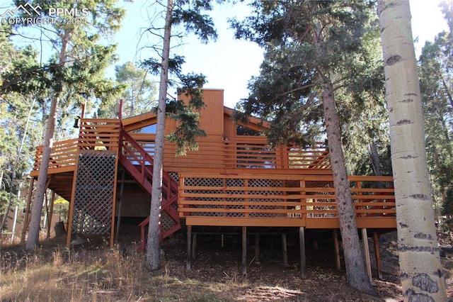 back of house with a wooden deck