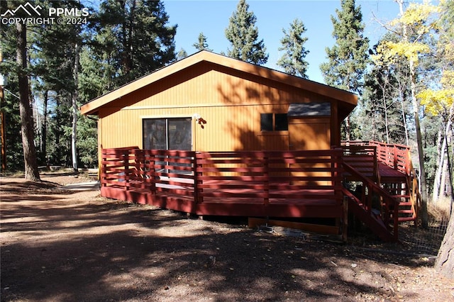 view of property exterior with a wooden deck