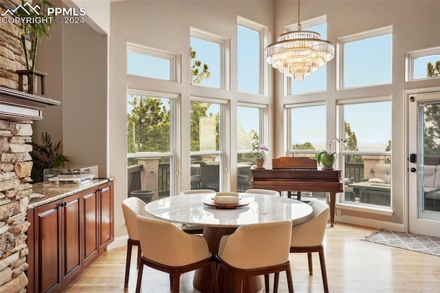 sunroom featuring an inviting chandelier and a wealth of natural light