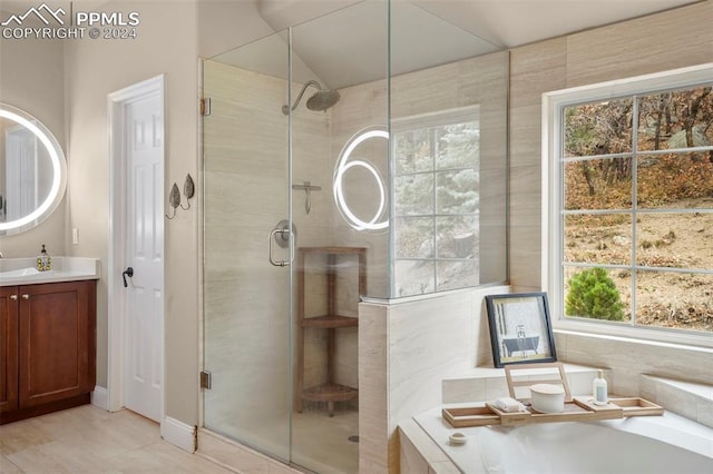 bathroom featuring vanity, tile patterned floors, a bath, and a shower stall