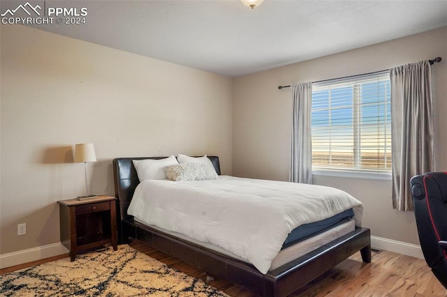 bedroom featuring baseboards and light wood-type flooring