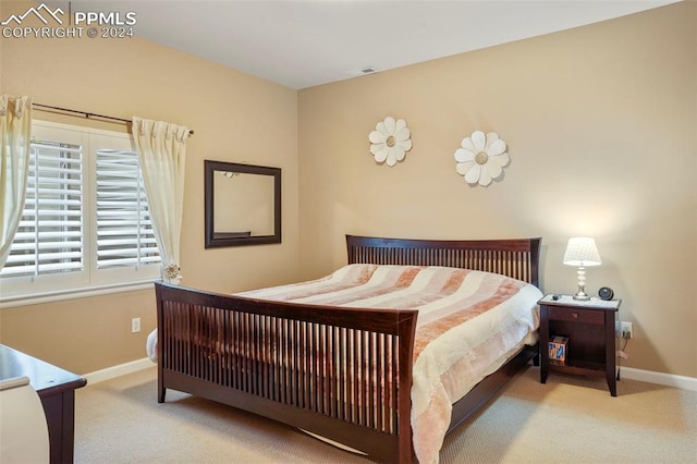 bedroom with carpet floors, baseboards, and visible vents