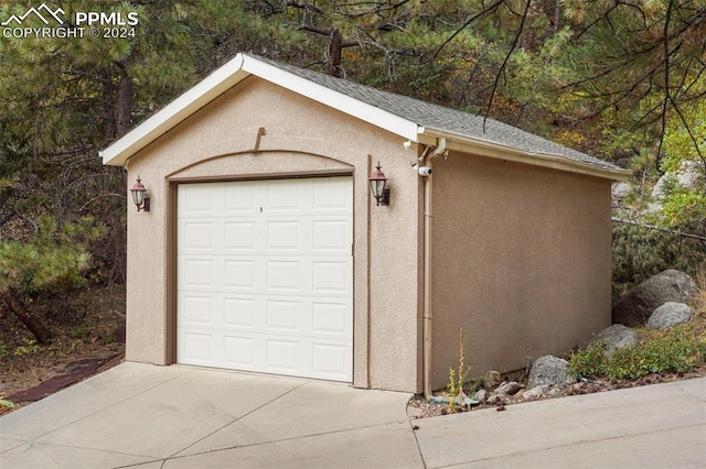 detached garage featuring driveway