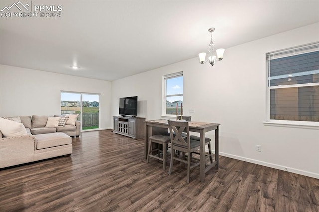 dining area featuring an inviting chandelier and dark hardwood / wood-style flooring