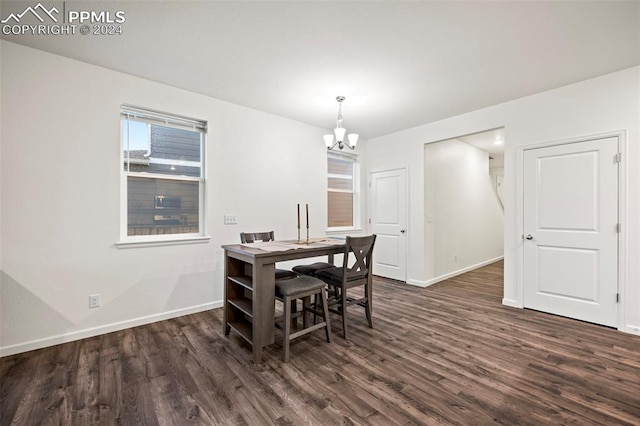 dining room with a chandelier and dark hardwood / wood-style flooring