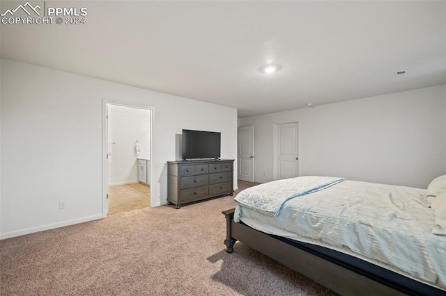 carpeted bedroom with connected bathroom